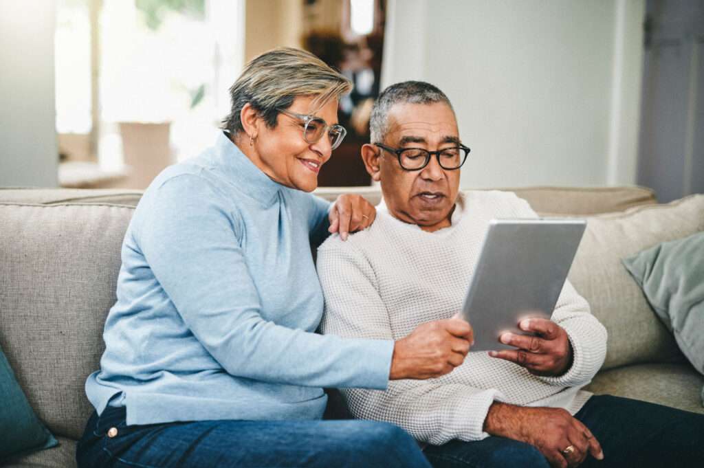 senior couple using tablet to schedule using online patient self-scheduling software