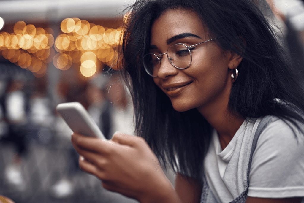 woman checking phone for simplified patient scheduling