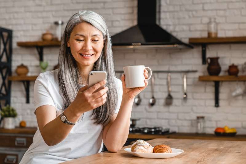 woman using smartphone for managing Patient Intake Software