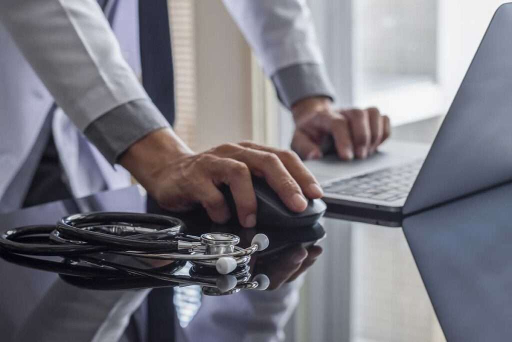 medical personnel using laptop patient scheduling app