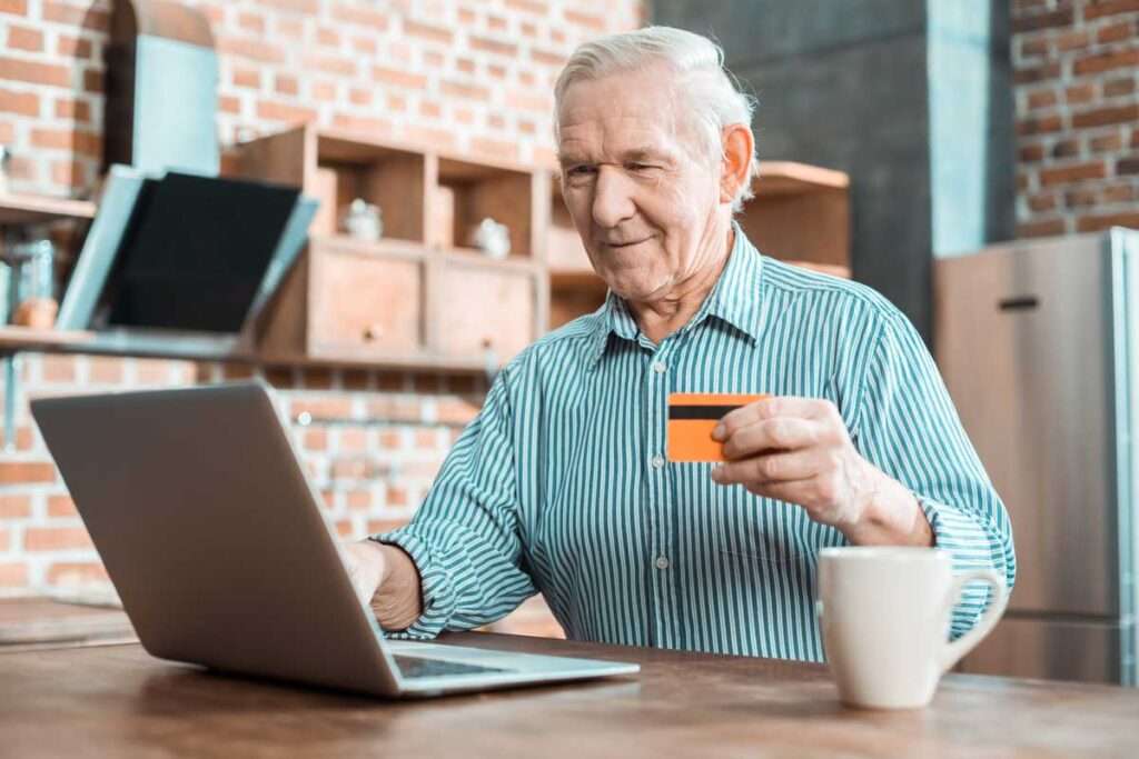 senior man using Patient eRegistration solution on laptop
