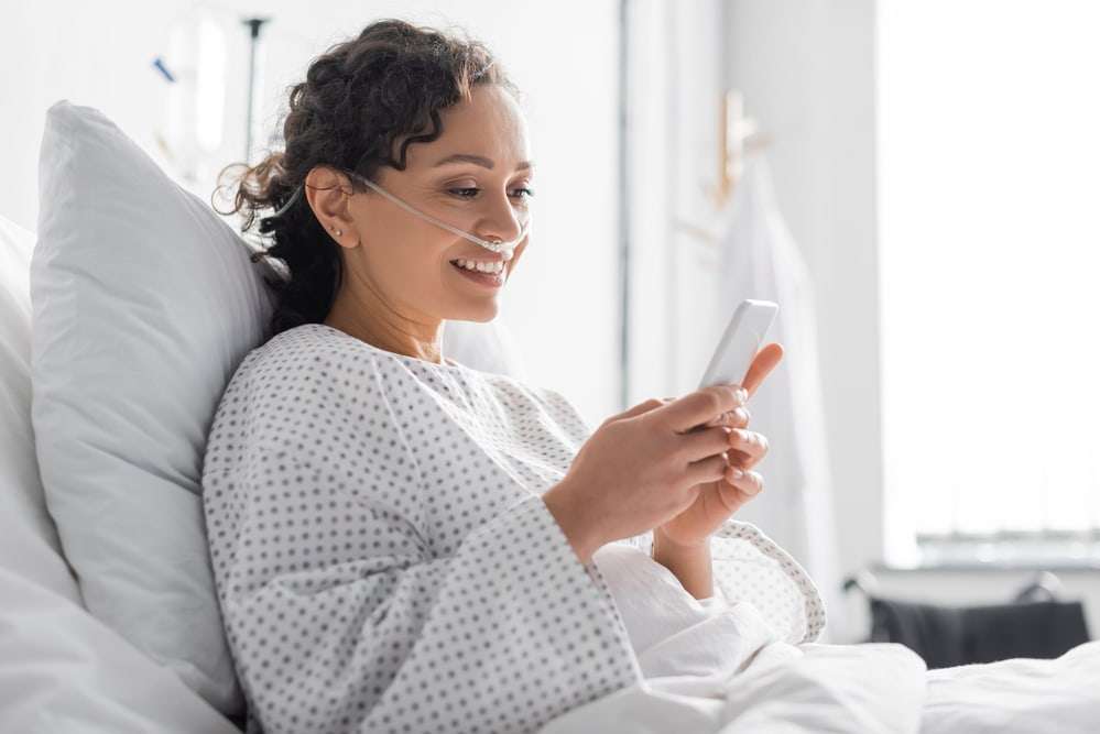 smiling patient using cell phone for Healthcare Intelligent Automation