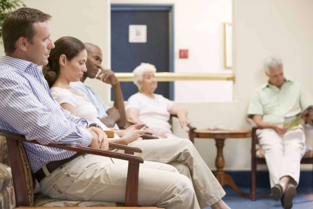 patients in waiting room after using online patient appointment booking system