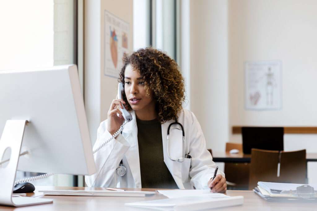 Female doctor on phone inquiring about Dash Patient engagement solution