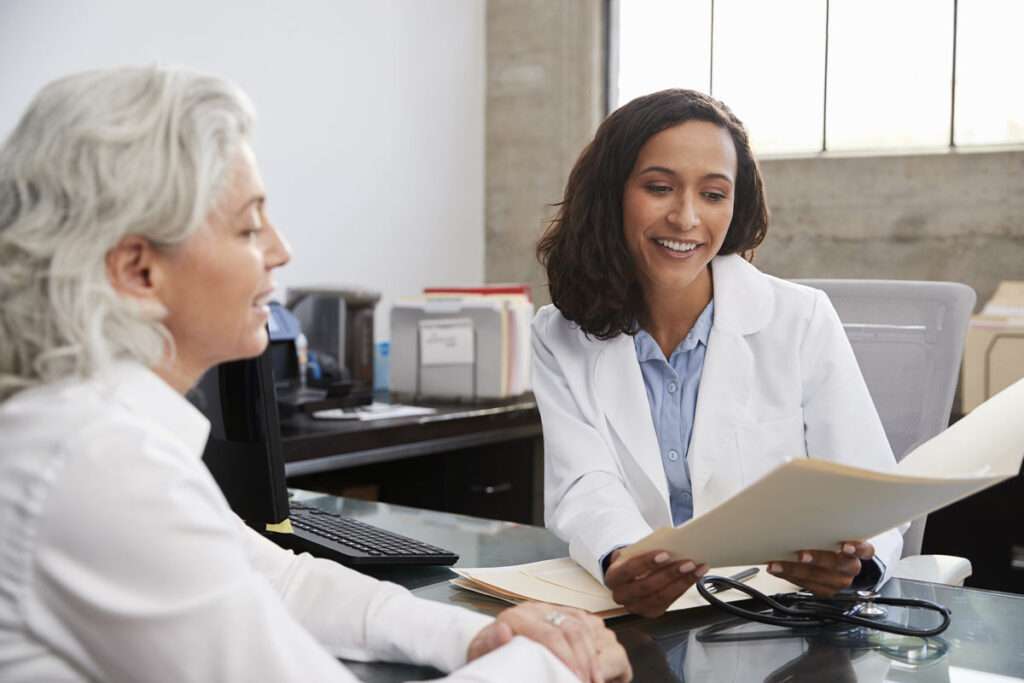 Female physician engaged in patient care because of the benefits of healthcare automation