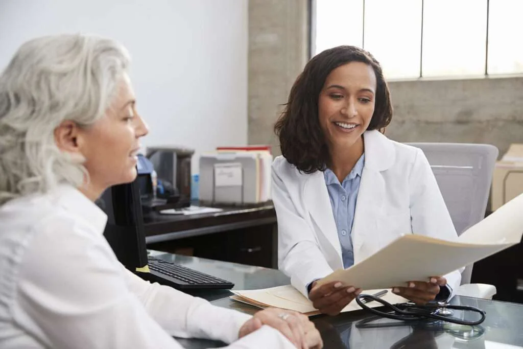 Female physician engaged in patient care because of the benefits of healthcare automation