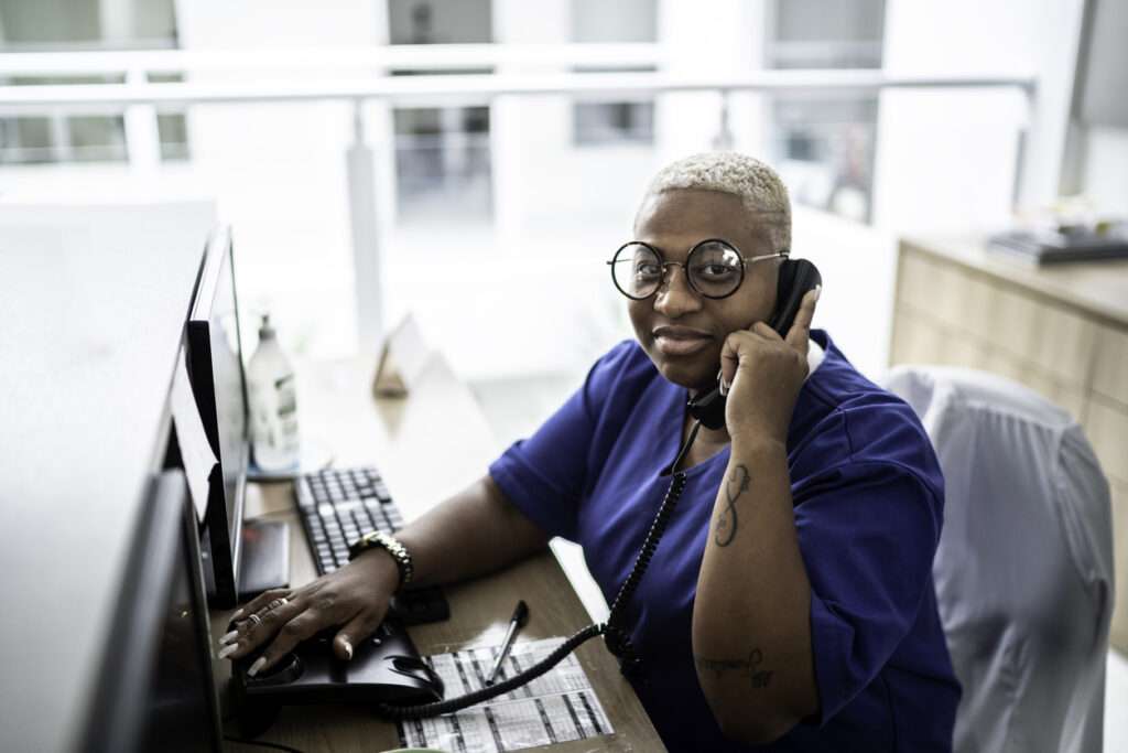 Healthcare scheduler on phone wishing patients would use Dash Chat