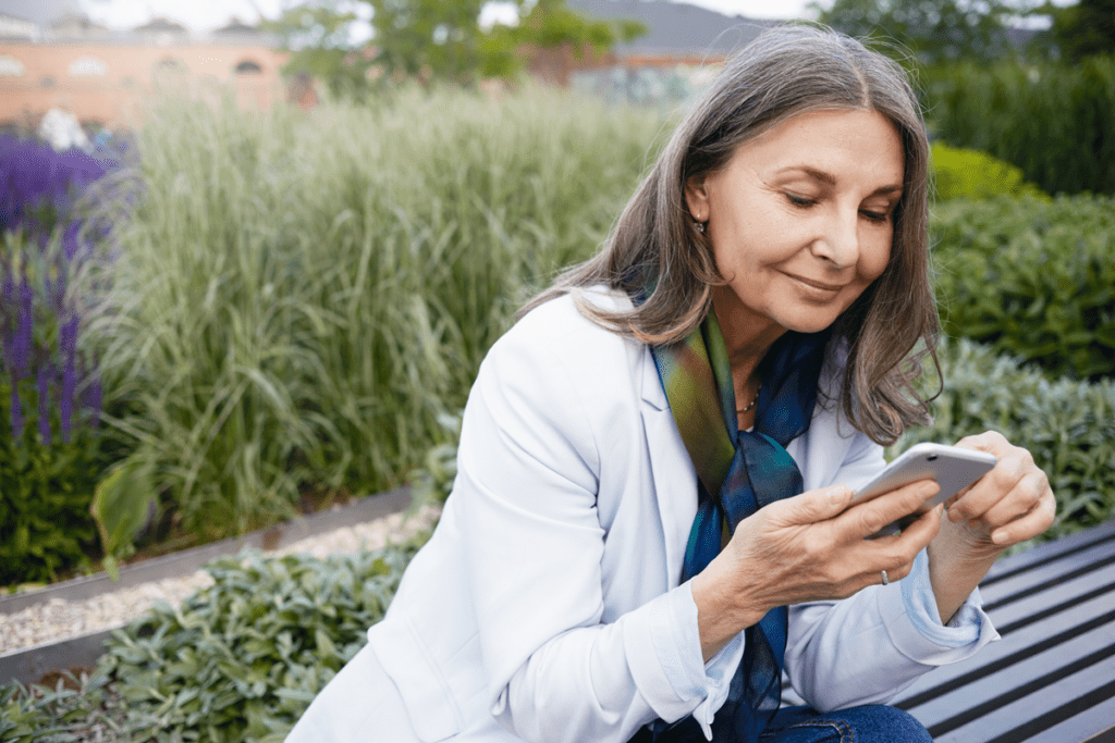 senior woman using smart phone with Intake Software