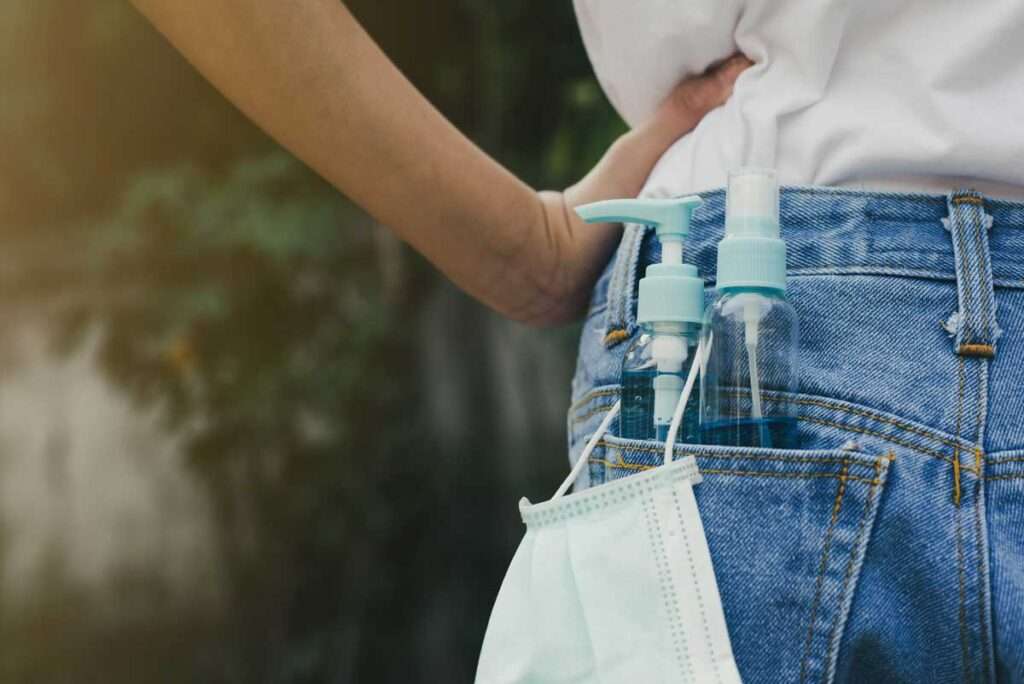 mask sanitizer in back jean pocket of woman