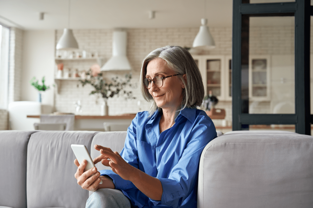 senior woman using smartphone engaged in a Patient Online Payment Solution