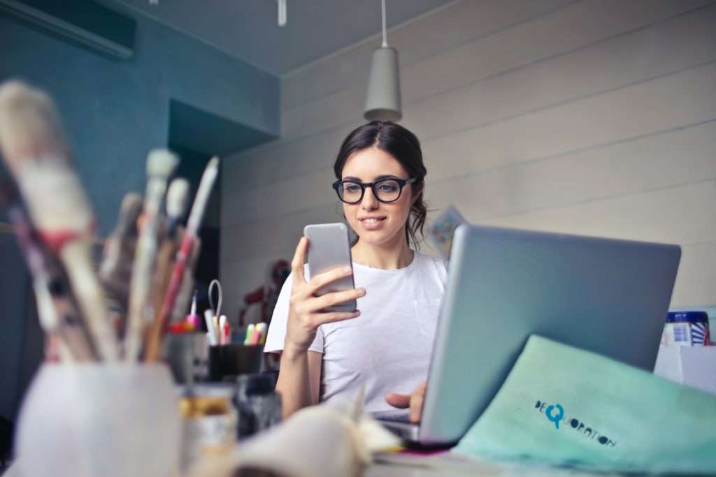 woman holding cell phone for patient scheduling and communication