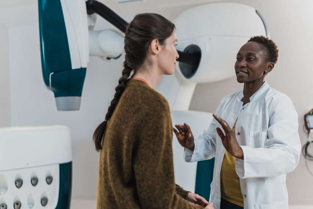 female doctor explains online patient appointment system with patient