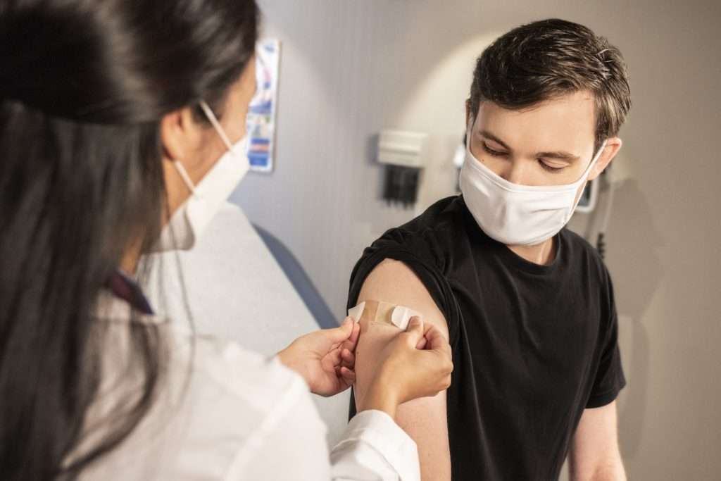 Patient receiving vax with Relatient healthcare engagement companies