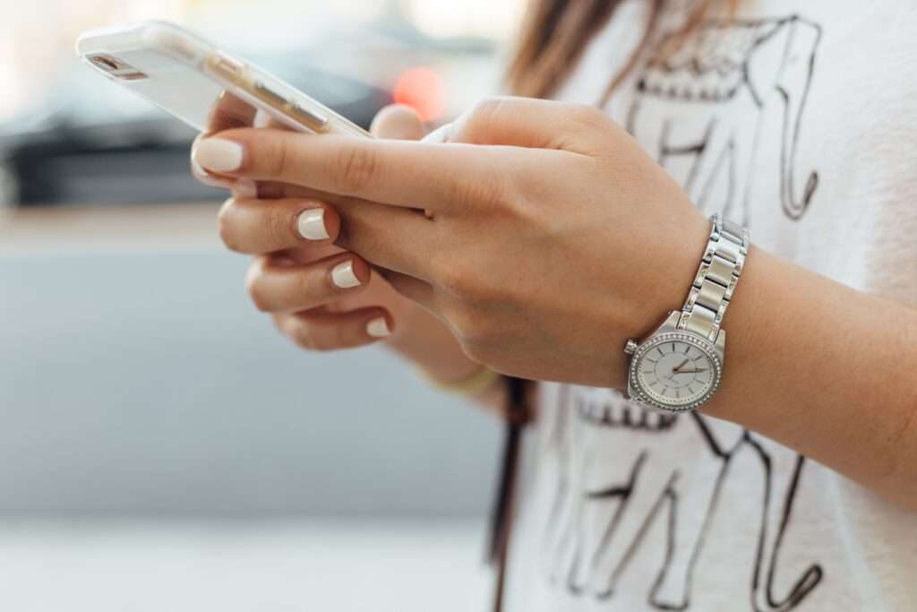 person using mobile phone for patient self-scheduling