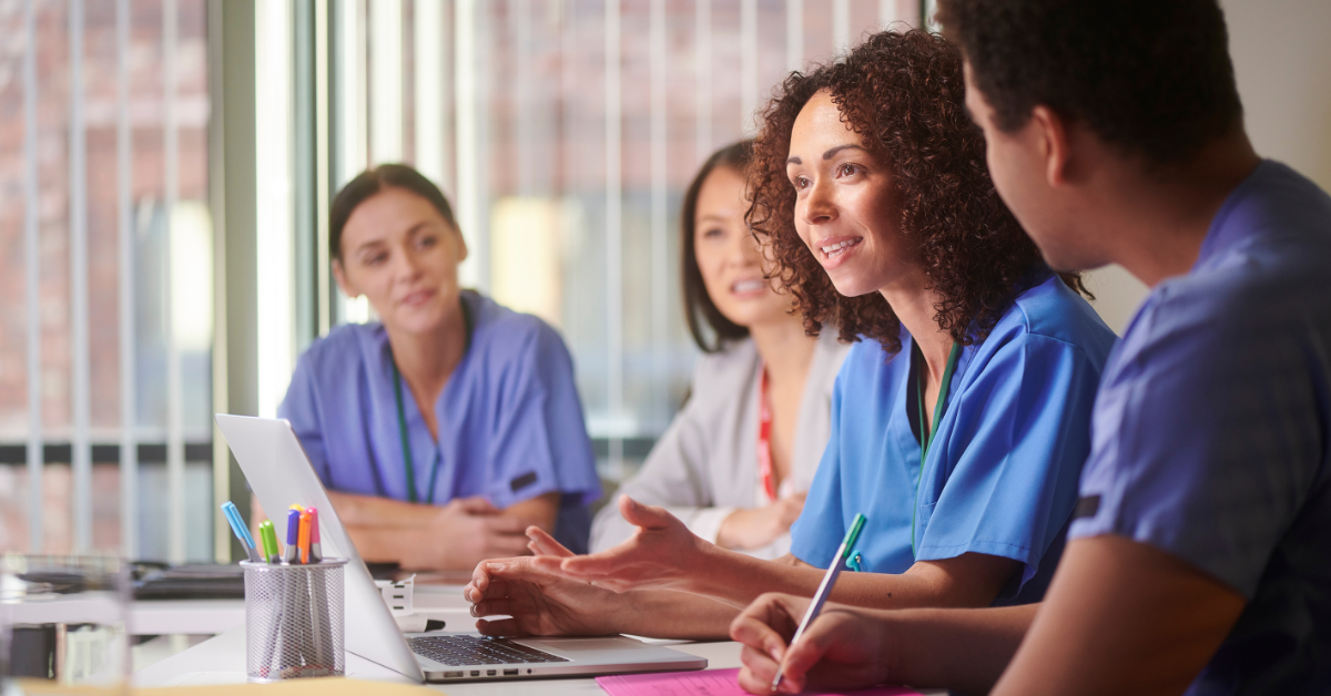 health care providers sitting in an office discussing the ROI of Scheduling and Voice AI