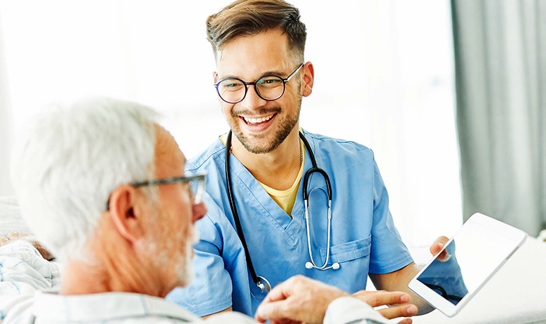 healthcare provider engaging with elderly patient | modernizing healthcare ops white paper